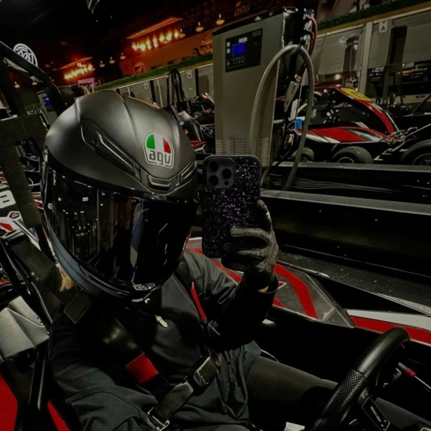 Pro racer holding BasedCarbon phone case
